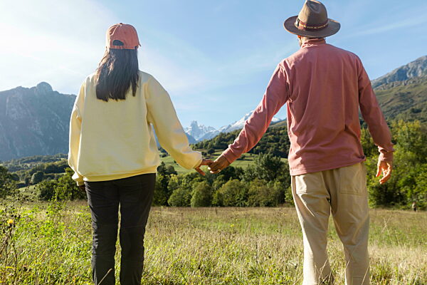 Couple holding hands in Picos de Europa mountains enjoying nature