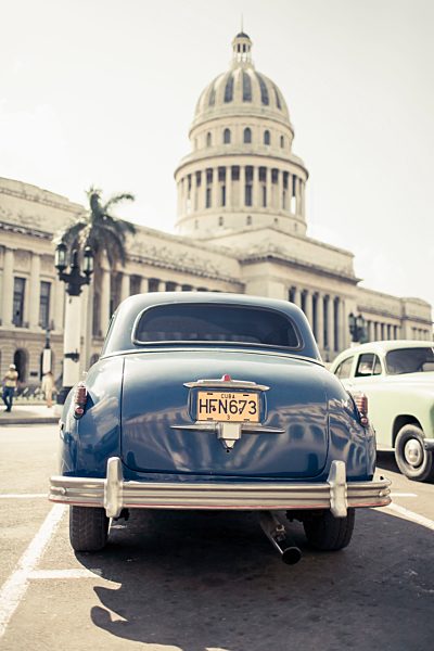 Cuba, Havana, blue vintage car parking in front of capitol