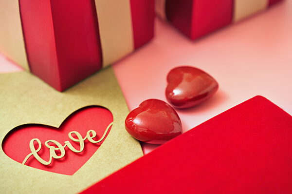 Valentine's Day love letter with heart shaped gift and red accents