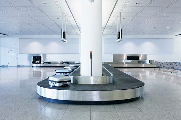 Germany, Munich, baggage conveyor belt with luggage at the airport