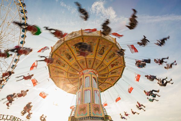 Germany, Stuttgart, ferris wheel and chairoplane at Cannstatter Wasen fairground