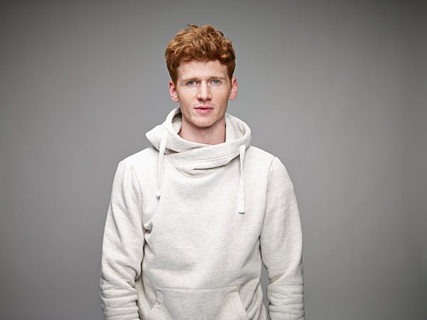Portrait of redheaded man wearing white hooded jacket
