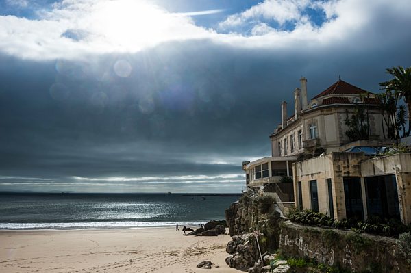 Portugal, Cascais, dramatic light over the beach and a old villa