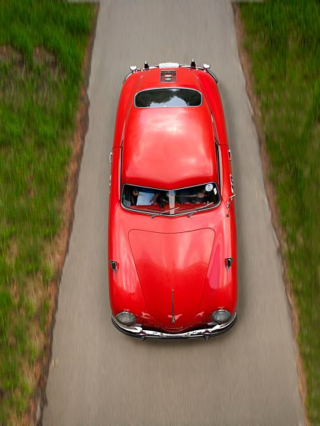 Germany, Wiesbaden, red Porsche 956 driving on country road