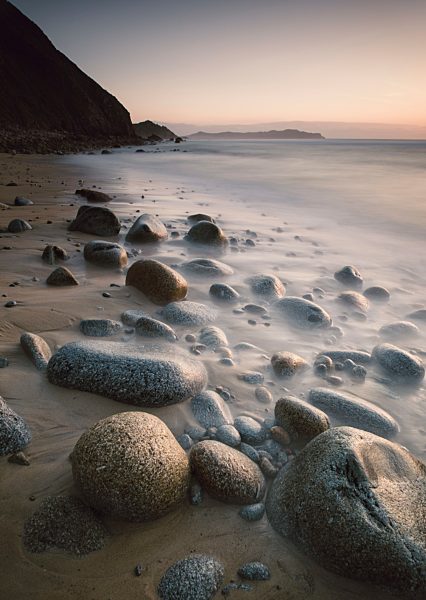 Spain, Galicia, Valdovino, Rocky beach at sunset