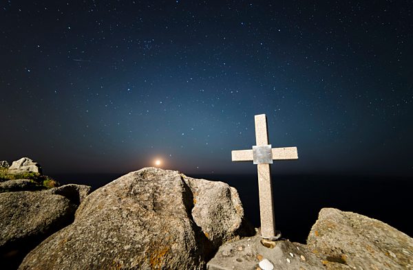 Spain, Galicia, Ferrol, Moonset in a place of the galician coast with a stone cross on the foreground