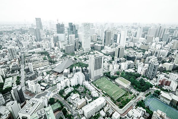 Japan, Tokyo, cityscape with soccer field