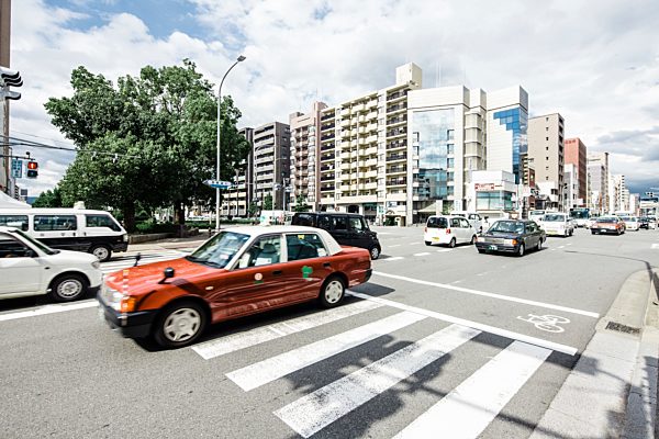 Japan, Kyoto, cars on street, houses in background