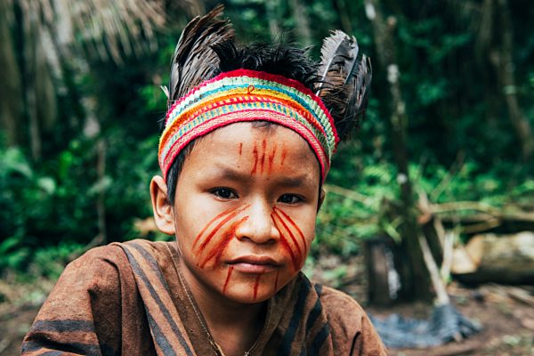 Peru, Madre de Dios Region, portrait of young boy wearing indigenous clothes