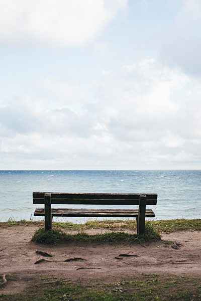 Germany, Nienhagen, wooden bench with view to the sea