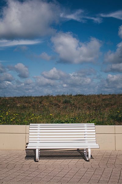 Germany, Mecklenburg-Western Pomerania, Warnemuende, white bench on promenade