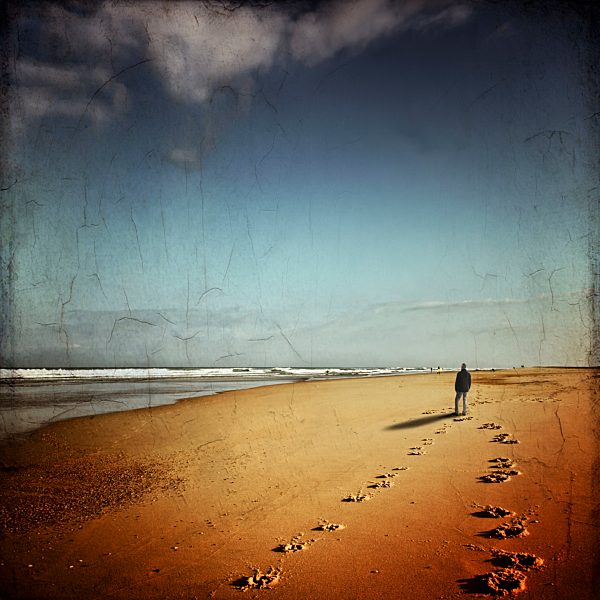 France, Contis-Plage, man walking on the beach looking to the sea