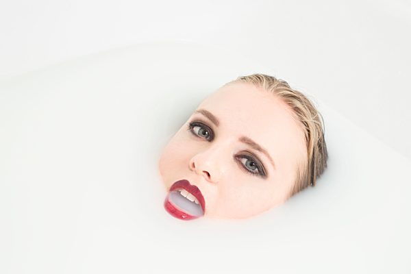 Young woman in milk bath