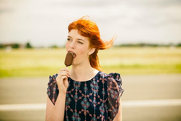 Portrait of young woman with ice lolly