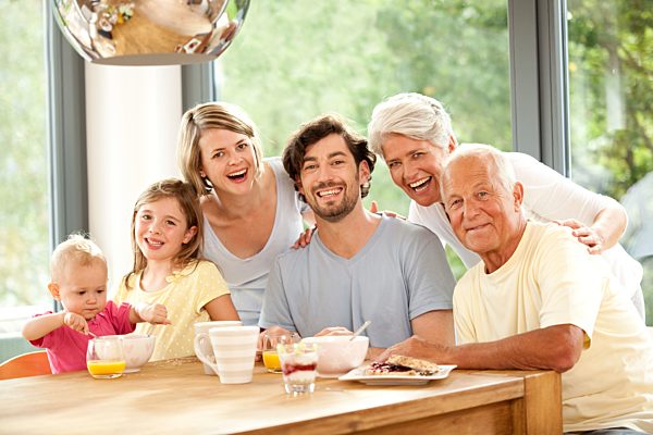 Portrait of happy extended family at breakfast table