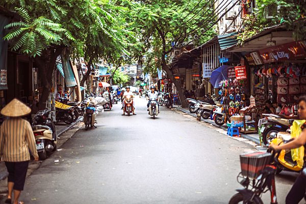 Vietnam, Hanoi, city street view with people working and moving
