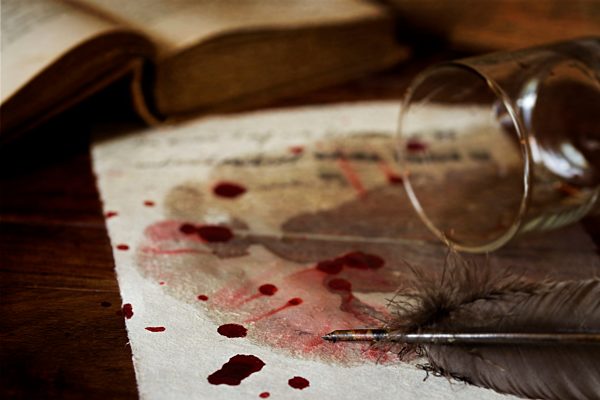 Letter on parchment paper with blood drops, fallen whiskey glass and quill