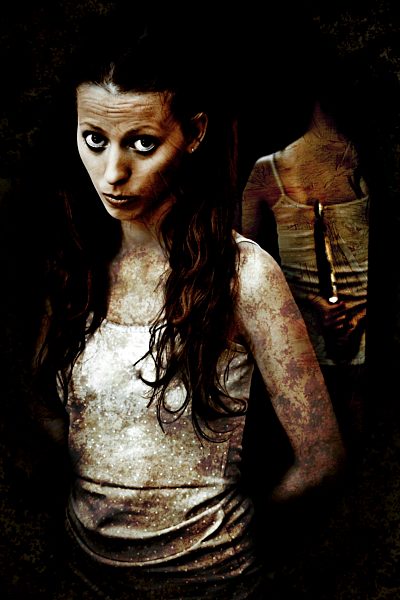 Portrait of woman hiding knife behind her back