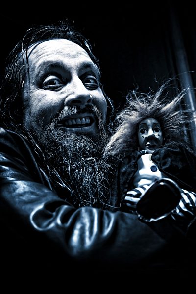 Portrait of mad man with hand puppet