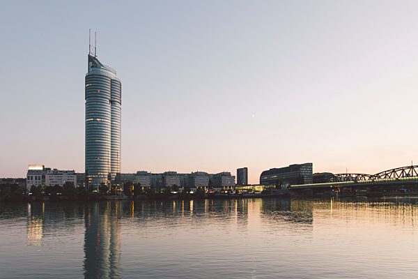 Austria, Vienna, Donau City, Danube River and Millenium Tower in the evening