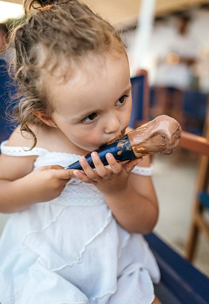 Little girl eating chocolate icecream