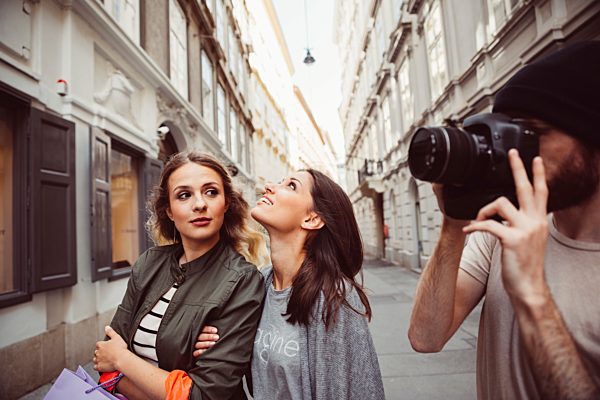 Austria, Vienna, three tourists exploring the old town