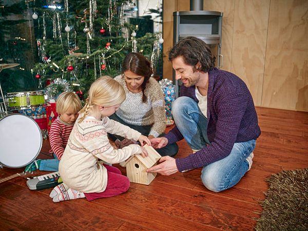 Parents playing with daughters on Christmas Eve