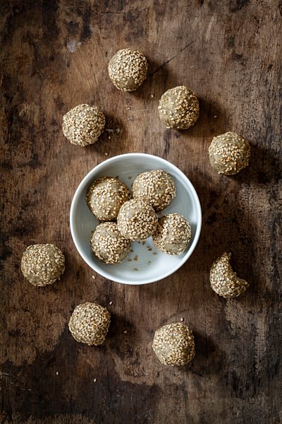 Bowl of small vegan balls made of quinoa flakes, sesame, sunflower and hemp seed