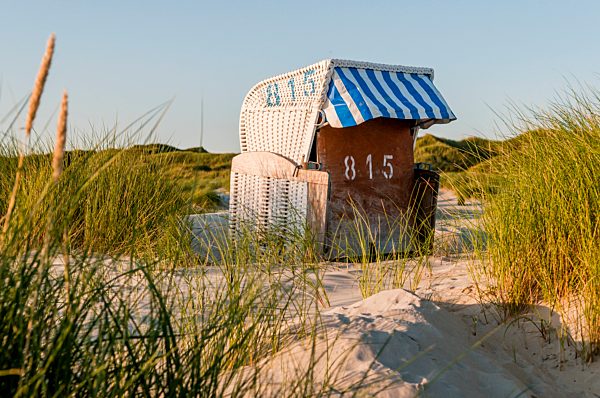 Germany, Amrum, locked hooded beach chair in dunes