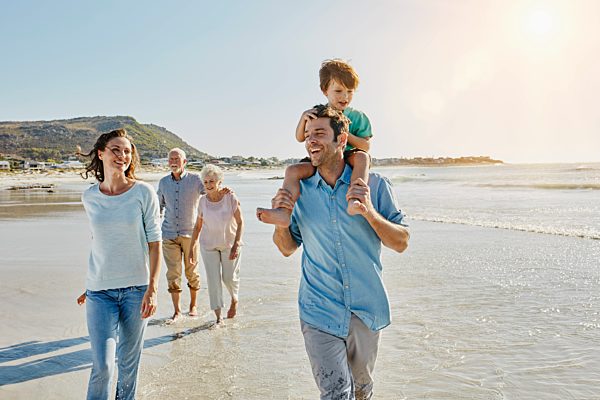 South Africa, Cape Town, three generations family strolling on the beach