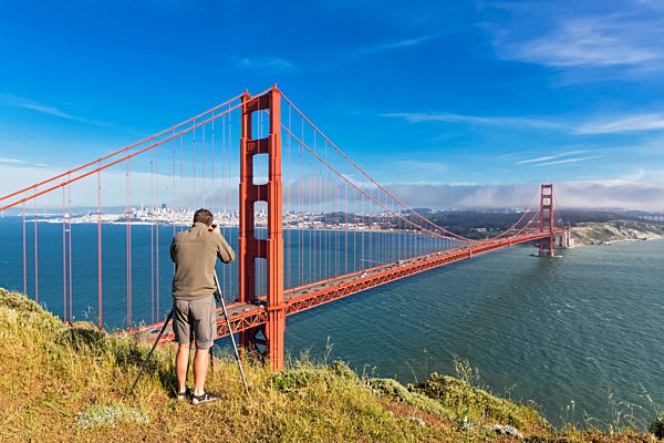 USA, California, San Francisco, man taking picture from skyline and Golden Gate Bridge