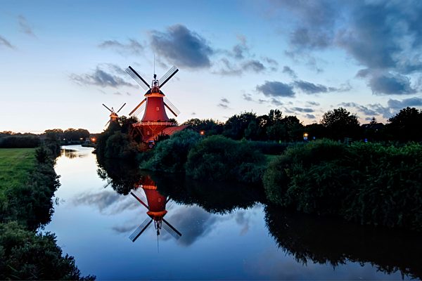 Germany, Lower Saxony, Greetsiel, traditional windmills in the evening light