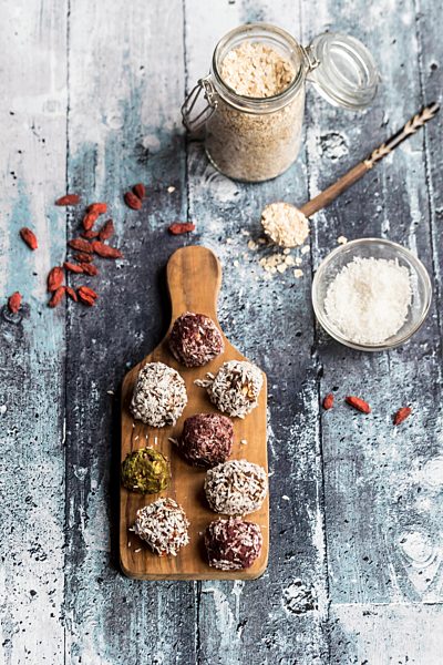 Various Bliss Balls on wooden board