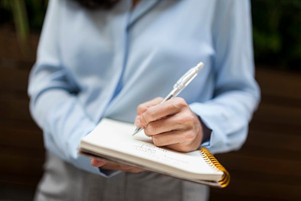 Close-up of businesswoman taking notes