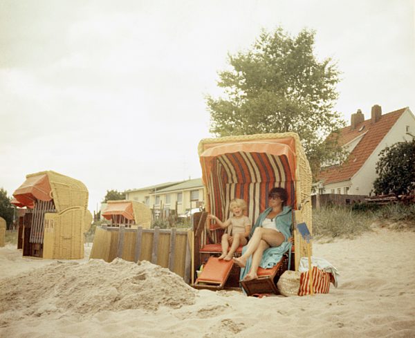 A mother and her son sitting in a beach chair
