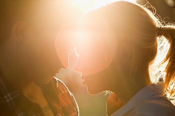 A passionate young couple face to face, extreme close up