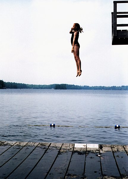 A girl jumping into a lake