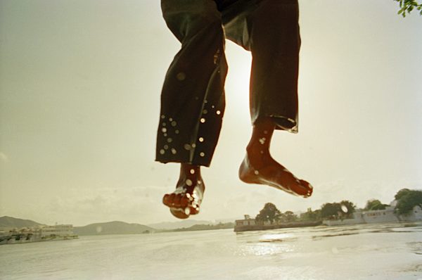 A person's legs jumping into water