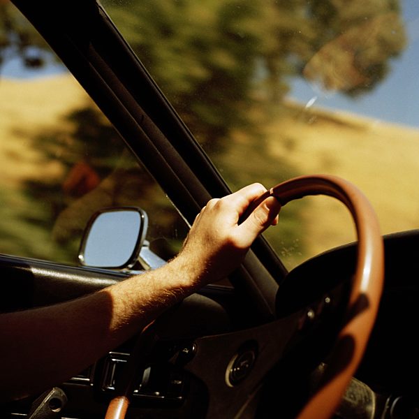 A person's hand on a steering wheel