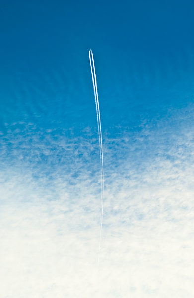An airplane with a vapor trail