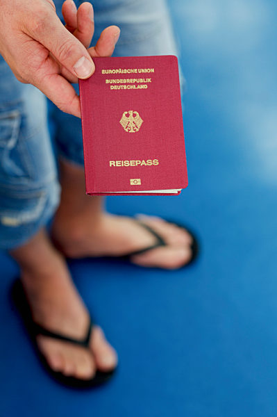 Detail of a man holding a German passport