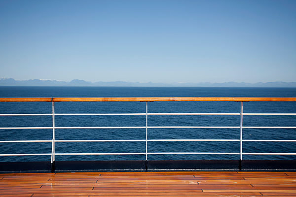 Sun shining on the boat deck of a passenger ship, Canadian coastline in background