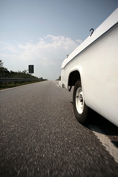 A car driving on a multiple lane highway, close-up, part of