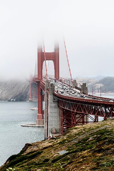 View of Golden Gate Bridge over bay of water during foggy weather, San Francisco, California, USA