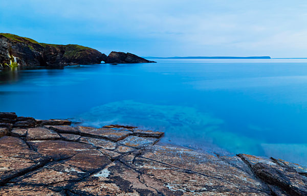 Tranquil Water Along The Coastline Of Orkney Islands At Dusk; Orkney, Scotland