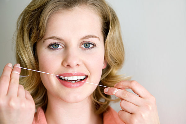 Woman with dental floss