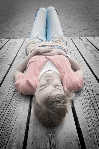 Young woman laying on decking