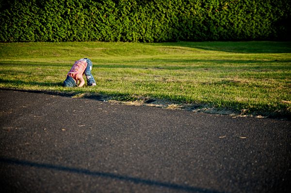 Young girl preparing for a somersault in a park at sunset, Otterburn park, Quebec