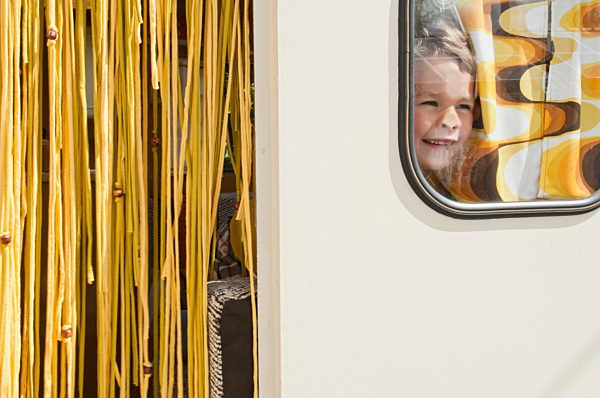 Boy looking through caravan window