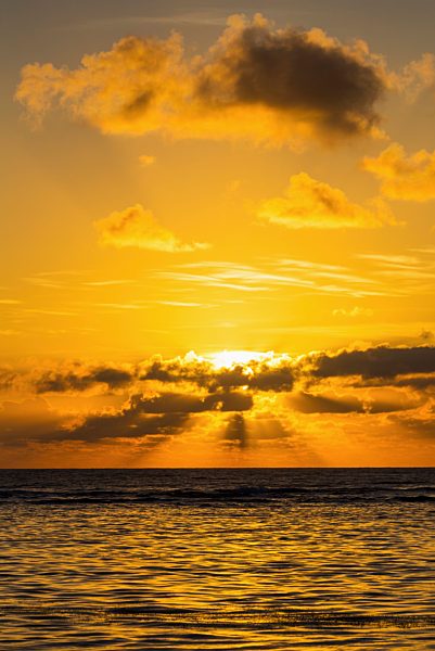 Dramatic Orange Sunrise With Light Reflecting In Ocean And Sun Rays Coming Through Clouds; Akumal, Quintana Roo, Mexico